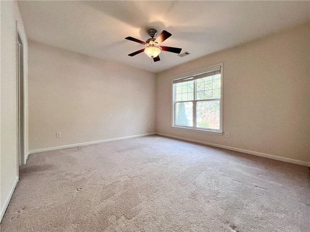 carpeted empty room featuring ceiling fan