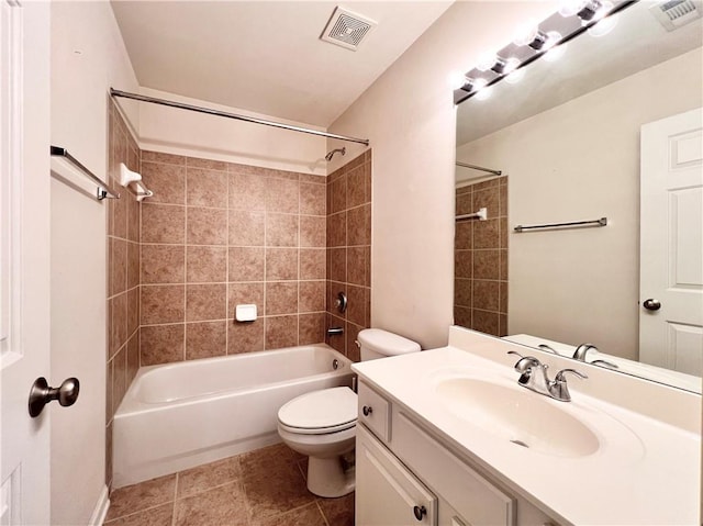 full bathroom featuring toilet, tiled shower / bath combo, vanity, and tile patterned floors