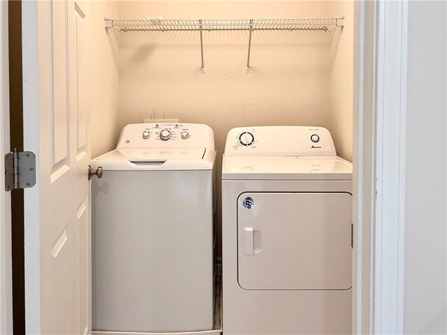 clothes washing area with washing machine and clothes dryer