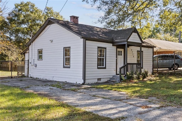 bungalow-style house with a front yard