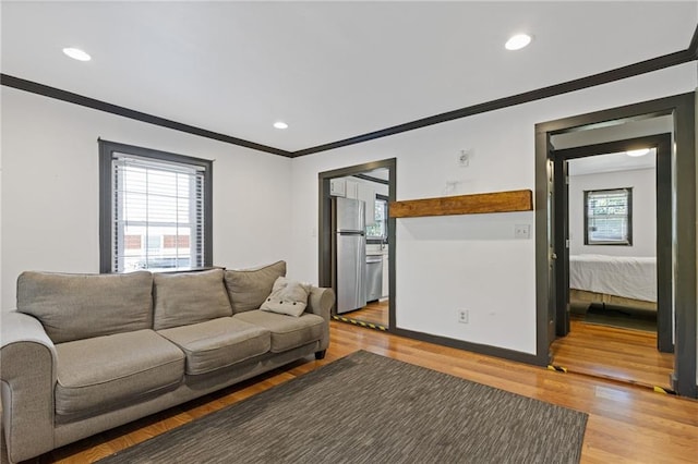 living room featuring hardwood / wood-style flooring and ornamental molding