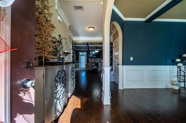 entrance foyer featuring ornate columns, dark hardwood / wood-style floors, and ornamental molding