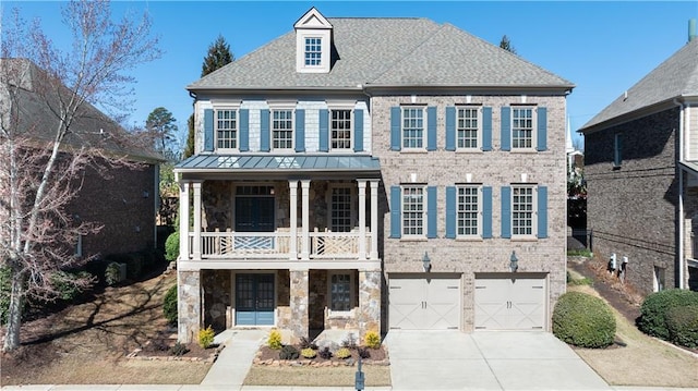 view of front of property with brick siding, french doors, a balcony, stone siding, and driveway