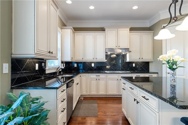 kitchen with under cabinet range hood, appliances with stainless steel finishes, crown molding, and a sink