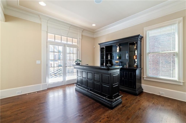 bar featuring dark wood finished floors, visible vents, crown molding, and baseboards