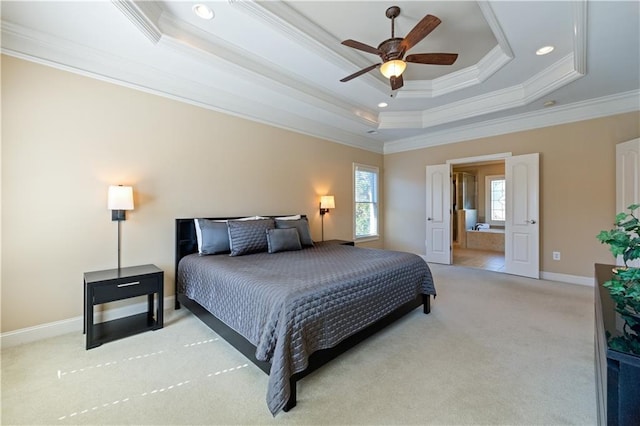 bedroom featuring light colored carpet, a raised ceiling, baseboards, and ornamental molding