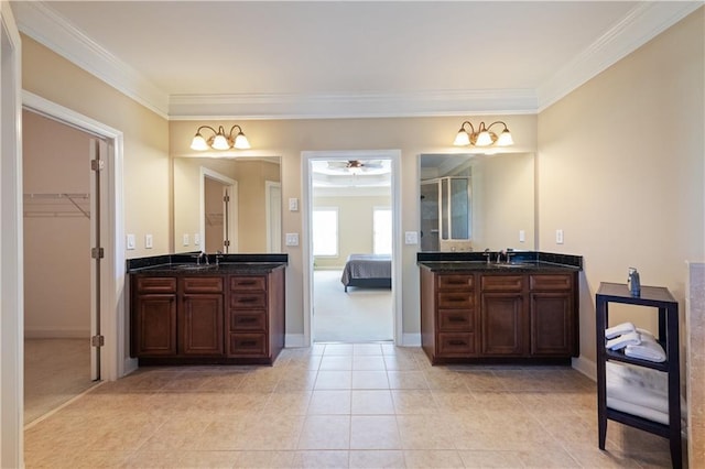 full bathroom with crown molding, two vanities, and a sink