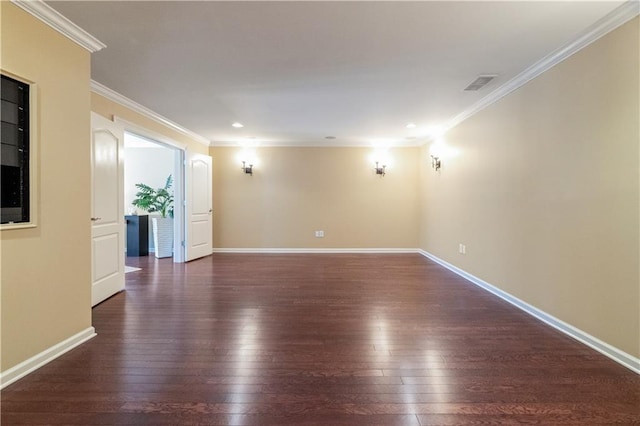 unfurnished room with hardwood / wood-style flooring, crown molding, baseboards, and visible vents