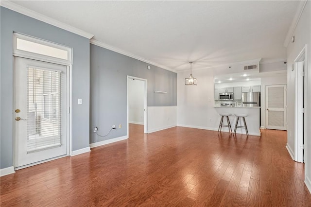 1101 Juniper St NE Unit 415, Atlanta, GA 30309 - unfurnished living room with wood finished floors, ornamental molding, and baseboards