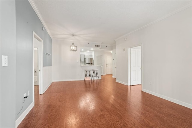 1101 Juniper St NE Unit 415, Atlanta, GA 30309 - unfurnished living room featuring crown molding, wood finished floors, and baseboards