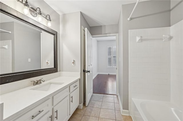 1101 Juniper St NE Unit 415, Atlanta, GA 30309 - bathroom featuring bathtub / shower combination, tile patterned floors, baseboards, and vanity
