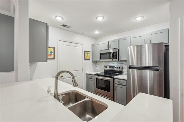 1101 Juniper St NE Unit 415, Atlanta, GA 30309 - kitchen featuring appliances with stainless steel finishes, a sink, gray cabinets, light countertops, and recessed lighting