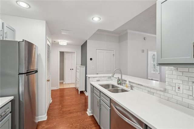 1101 Juniper St NE Unit 415, Atlanta, GA 30309 - kitchen with stainless steel appliances, a sink, gray cabinets, light countertops, and crown molding