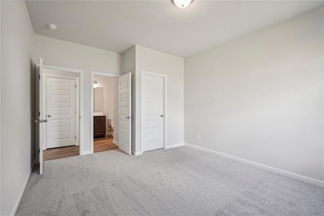 unfurnished bedroom featuring light colored carpet