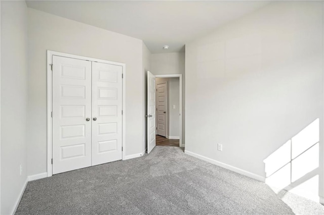 unfurnished bedroom with carpet and a closet