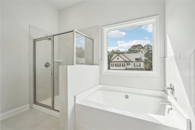 bathroom with separate shower and tub