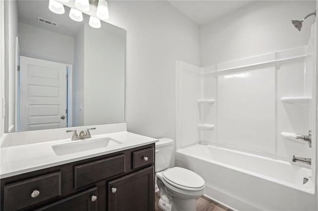 full bathroom featuring toilet, vanity, bathing tub / shower combination, and wood-type flooring