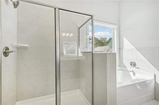 bathroom with separate shower and tub