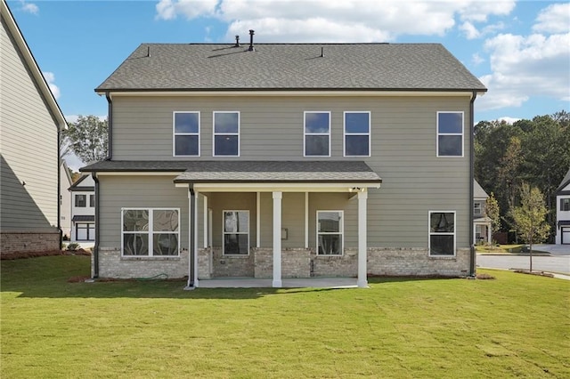 rear view of property with a lawn