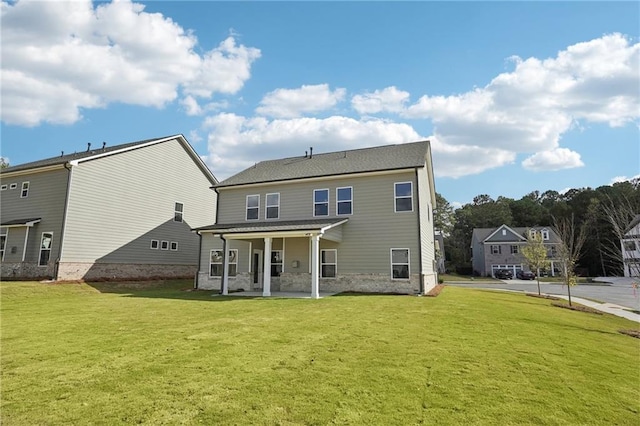 rear view of house with a lawn