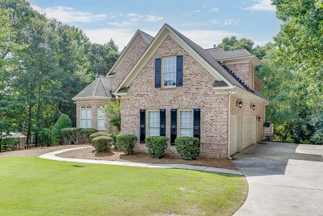 view of front of property featuring a garage and a front lawn