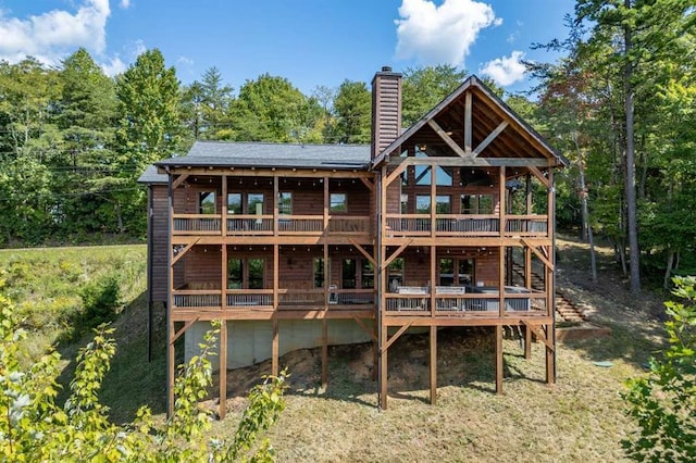 back of house with a wooden deck