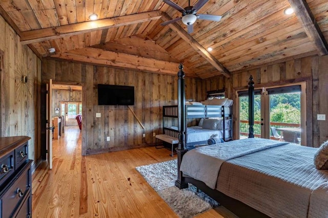 bedroom with multiple windows, wood walls, wooden ceiling, and light wood-type flooring