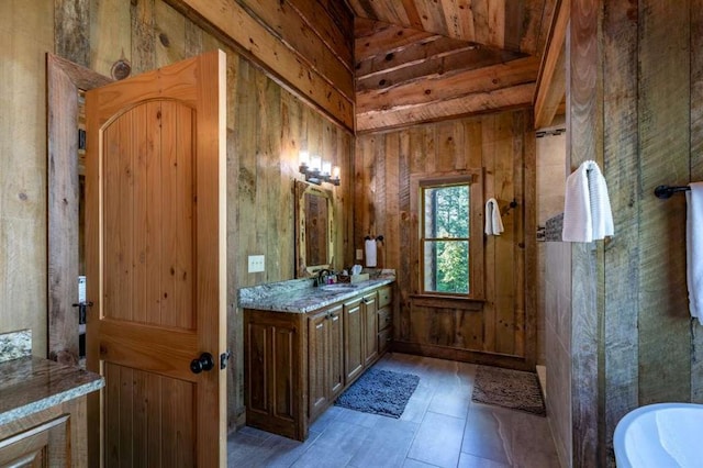 bathroom with wood ceiling, vanity, wooden walls, lofted ceiling, and a tub