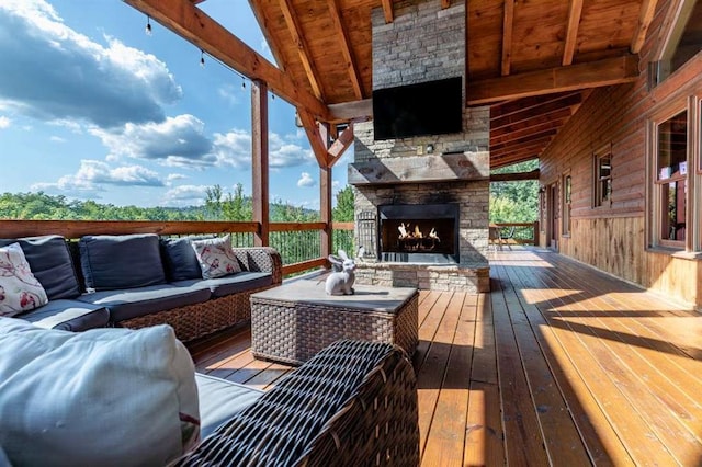 wooden terrace featuring an outdoor living space with a fireplace