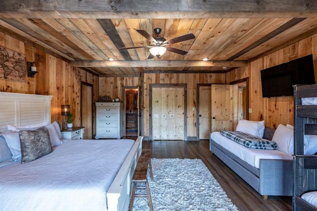 bedroom with wooden walls, dark hardwood / wood-style flooring, beamed ceiling, and wooden ceiling