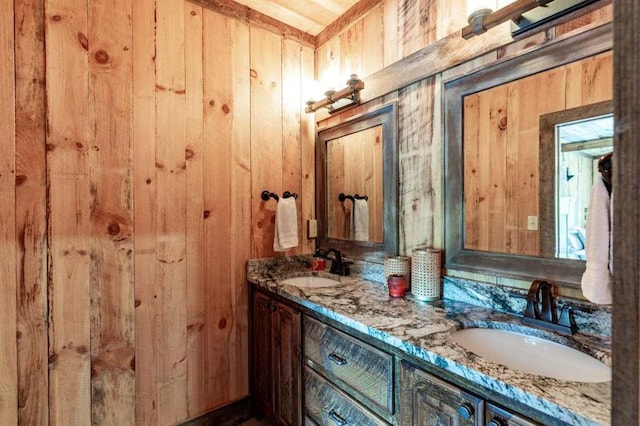 bathroom with wood walls and vanity