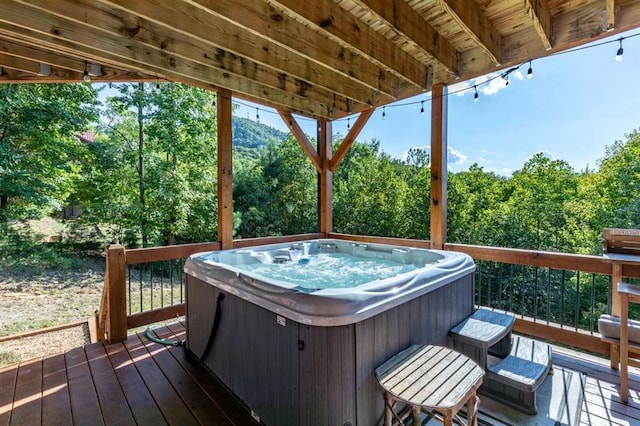 wooden deck with a hot tub