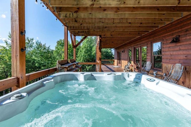 view of swimming pool featuring a hot tub