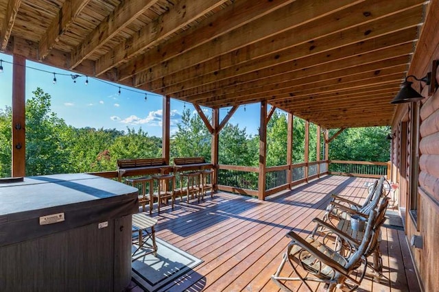 wooden terrace featuring a hot tub