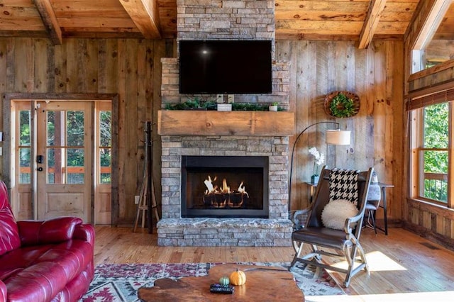 living room with hardwood / wood-style floors, wood walls, wood ceiling, and beamed ceiling