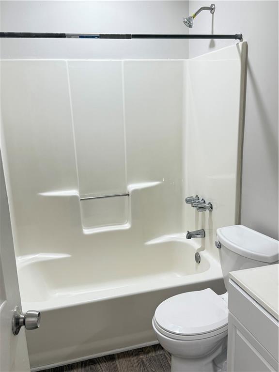 2115 Charter Ln, Lithonia, GA 30058 - full bathroom featuring toilet, shower / washtub combination, and vanity