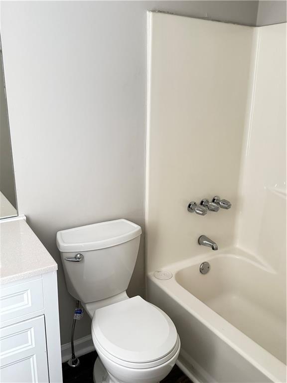 2115 Charter Ln, Lithonia, GA 30058 - full bathroom featuring shower / bathing tub combination, toilet, vanity, and baseboards