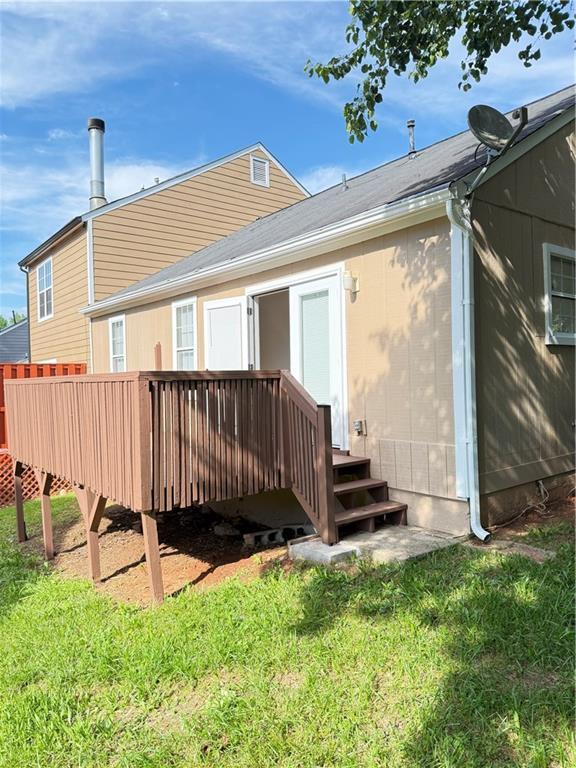 2115 Charter Ln, Lithonia, GA 30058 - back of house featuring a lawn and a deck