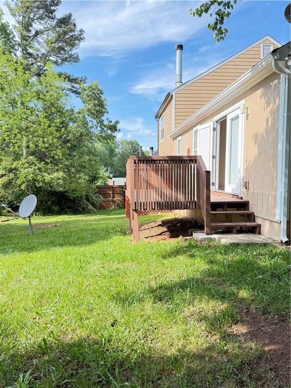 2115 Charter Ln, Lithonia, GA 30058 - view of yard featuring a deck