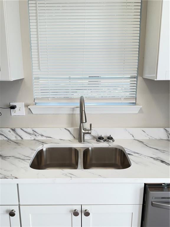 2115 Charter Ln, Lithonia, GA 30058 - room details featuring light stone countertops, a sink, and white cabinets