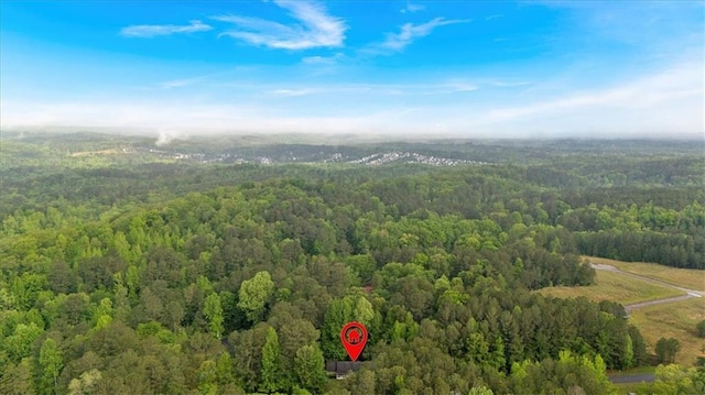 aerial view featuring a wooded view