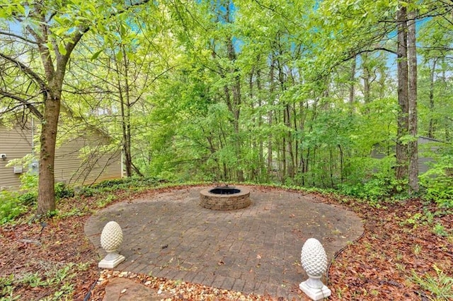 exterior space featuring a patio and an outdoor fire pit