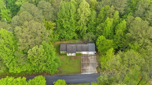 birds eye view of property featuring a view of trees