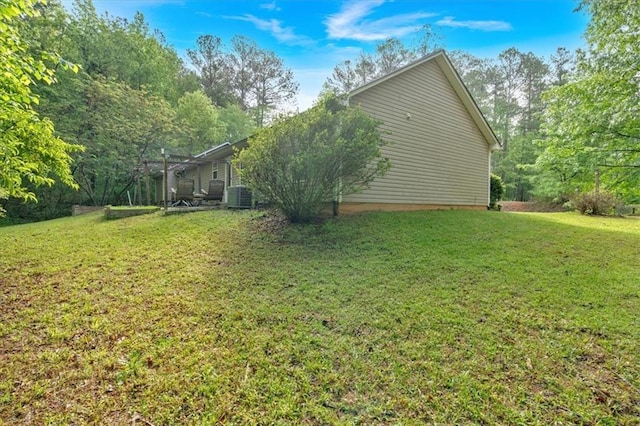 view of home's exterior with central AC unit and a lawn