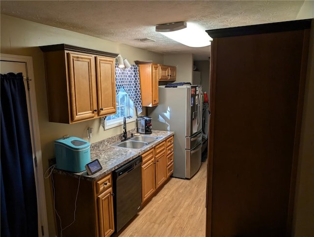 kitchen with black dishwasher, a textured ceiling, stainless steel fridge with ice dispenser, a sink, and light wood finished floors