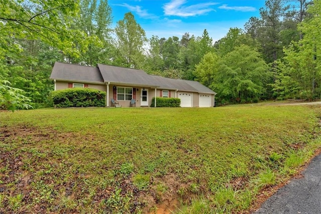 ranch-style house with an attached garage and a front lawn