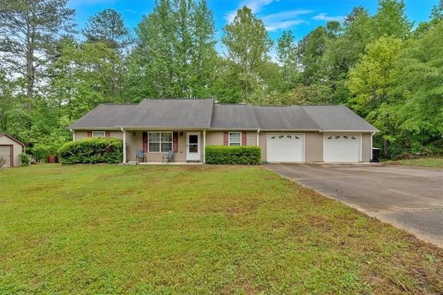 ranch-style home with driveway, an attached garage, and a front yard