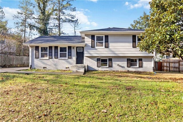 tri-level home featuring a front lawn