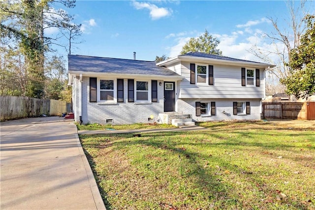 tri-level home with a front yard