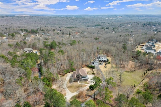 view of property location with a forest